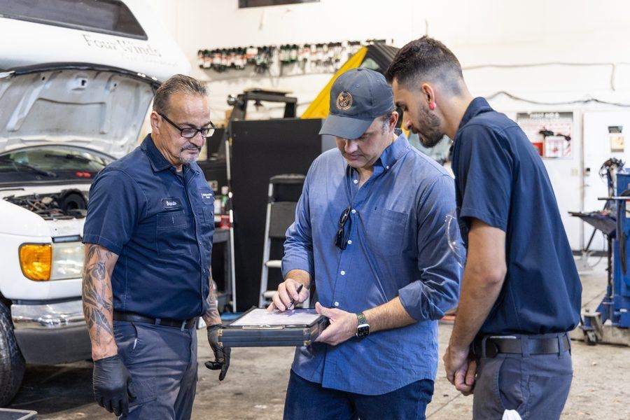 NH Repairs team reviewing service clipboard with client